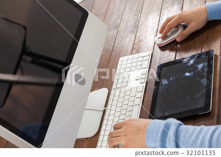 Man using laptop while writing on notepad Man using laptop while writing on notepad 32101135