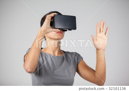 Woman using virtual reality headset 32101136