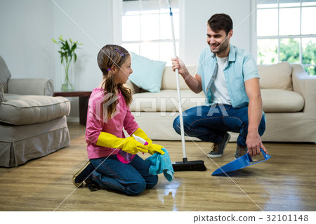Daughter helping father to clean floor 32101148