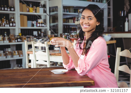 Portrait of beautiful woman having coffee 32101157