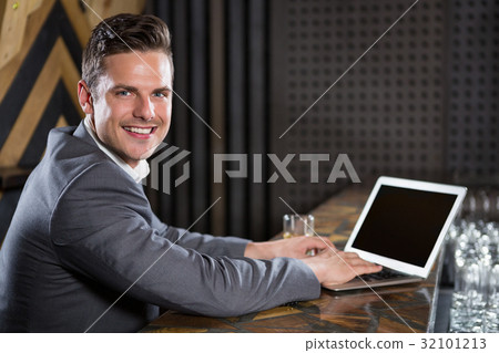 Man using laptop in bar counter Man using laptop in bar counter 32101213