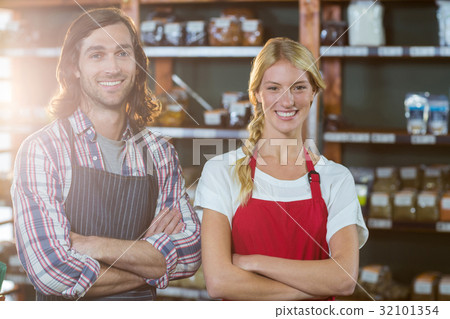 Smiling staffs standing with arms crossed in supermarket 32101354