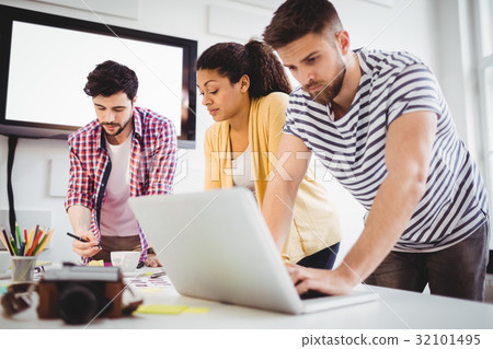 Coworkers working in meeting at creative office 32101495