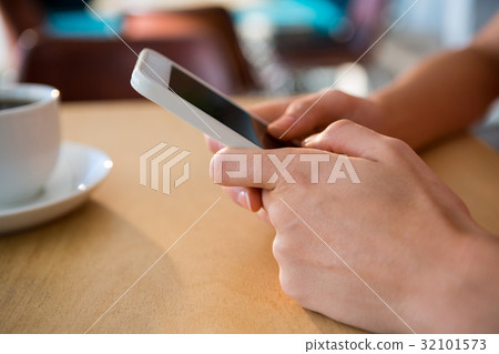 Close-up of hands using a mobile phone Close-up of hands using a mobile phone 32101573