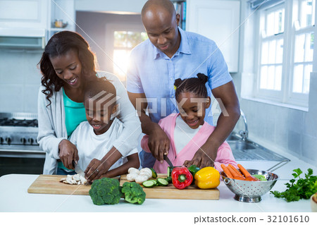 Happy family preparing food 32101610