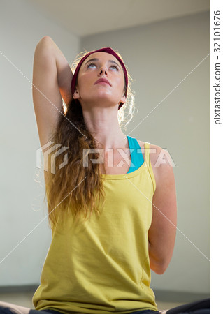 Woman doing gomukhasana pose 32101676