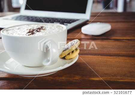 Coffee cup and cookies on a table 32101677