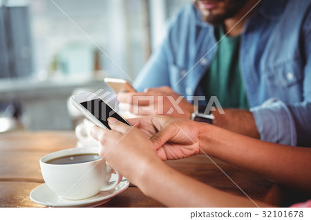 Hands of couple using mobile phone Hands of couple using mobile phone 32101678