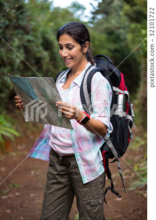 Female hiker looking at map Female hiker looking at map 32101722