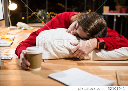 Tired businesswoman sleeping on the desk Tired businesswoman sleeping on the desk 32101941