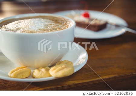 Cappuccino with cookies on plate Cappuccino with cookies on plate 32102086