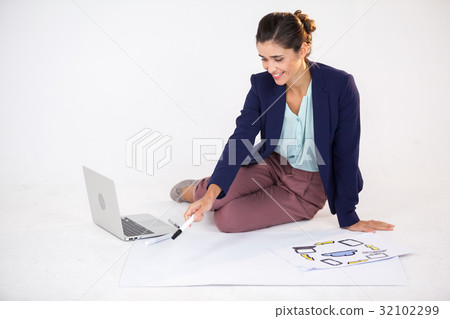 Businesswoman preparing a chart with icons Businesswoman preparing a chart with icons 32102299