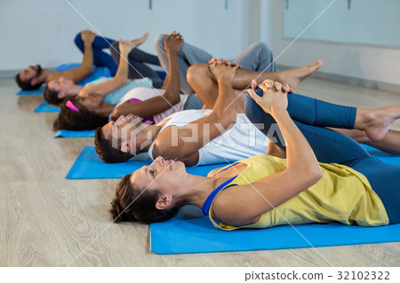Group of people doing leg flexes 32102322