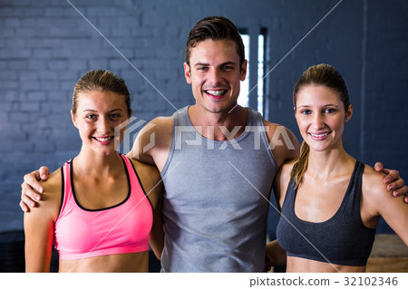 Male and female athletes against wall Male and female athletes against wall 32102346