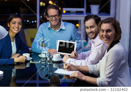 Businessman discussing work on digital tablet with colleagues 32102402