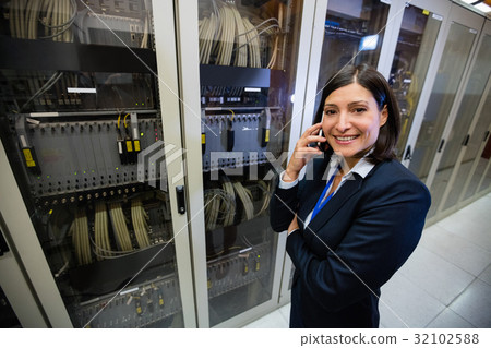 Technician talking on mobile phone 32102588