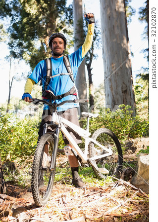 Excited mountain biker in forest 32102870