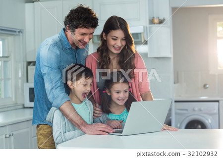 Happy family using laptop 32102932