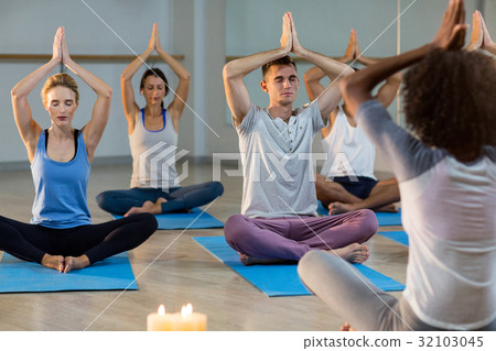 Instructor taking yoga class Instructor taking yoga class 32103045