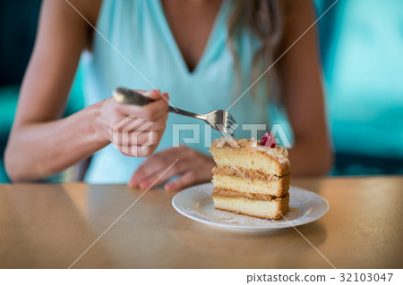 Woman eating dessert in cafe Woman eating dessert in cafe 32103047