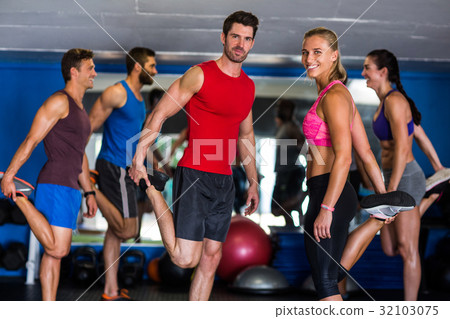Happy athletes standing on one leg Happy athletes standing on one leg 32103075