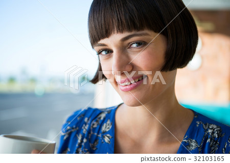 Smiling woman in a coffee shop 32103165