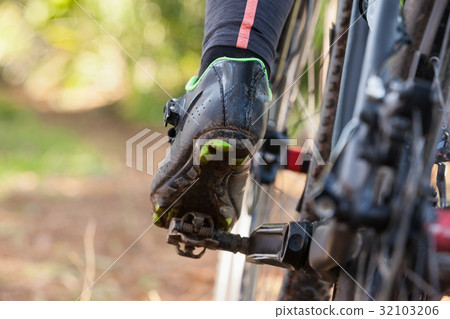 Low section of mountain biker riding bicycle 32103206