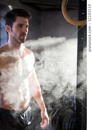 Male athlete standing by chalk dust Male athlete standing by chalk dust 32103519