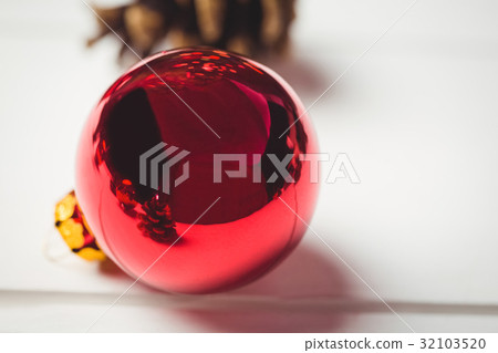 Red christmas bauble on wooden table Red christmas bauble on wooden table 32103520