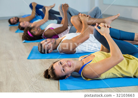 Group of people doing leg flexes Group of people doing leg flexes 32103663