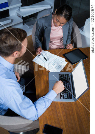 Businessman and businesswoman working in office 32103674