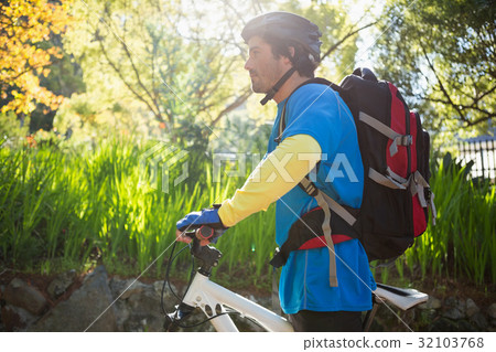 Male mountain biker with bicycle in the forest 32103768