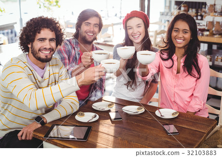 Group of happy friends holding cup of coffee 32103883