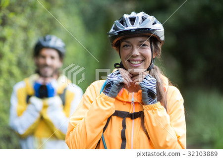 Female biker wearing bicycle helmet Female biker wearing bicycle helmet 32103889