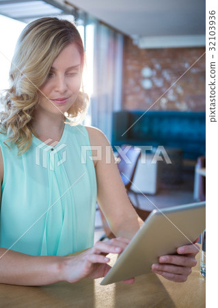 Woman using a digital tablet in the coffee shop Woman using a digital tablet in the coffee shop 32103936