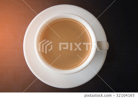 White cup of coffee on dark blue background White cup of coffee on dark blue background 32104165