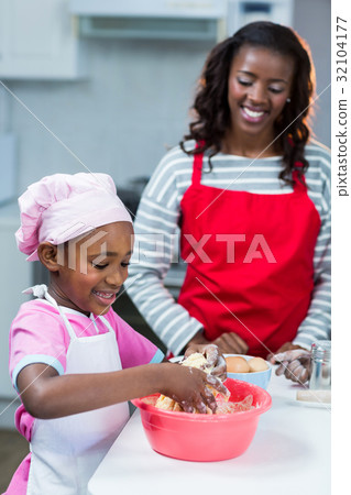 Girl preparing cake with mother 32104177