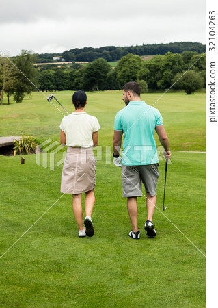 Couple walking on a golf course 32104263