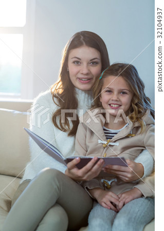 Mother and daughter reading a book Mother and daughter reading a book 32104937