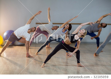 Group of people performing stretching exercise 32105059