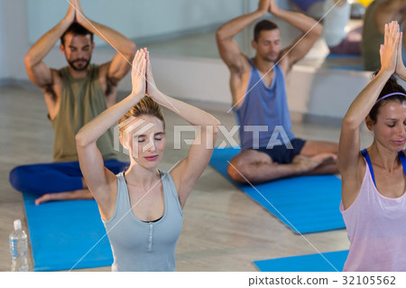 Group of people performing yoga Group of people performing yoga 32105562