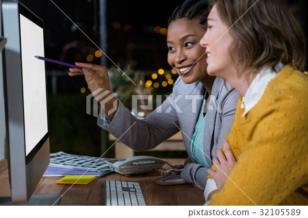 Businesswomen working on computer at their desk 32105589
