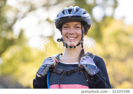 Female biker smiling with backpack Female biker smiling with backpack 32105596