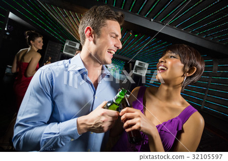 Happy couple toasting a beer bottles Happy couple toasting a beer bottles 32105597