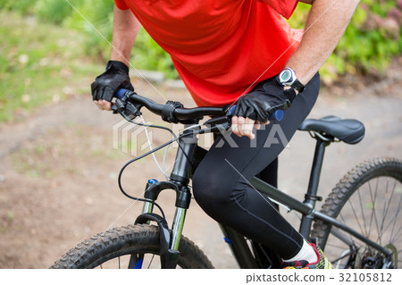 Male cyclist cycling in countryside Male cyclist cycling in countryside 32105812