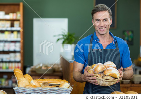 Portrait of male staff holding a basket of bread Portrait of male staff holding a basket of bread 32105831