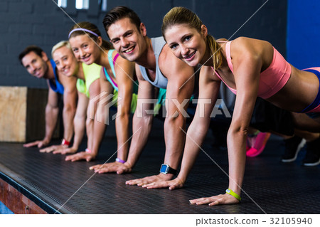 Male and female athletes doing push-ups 32105940