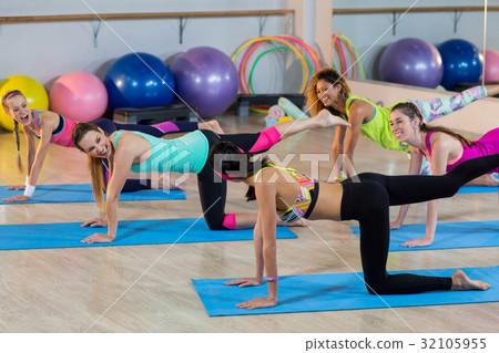 Group of women performing stretching exercise 32105955