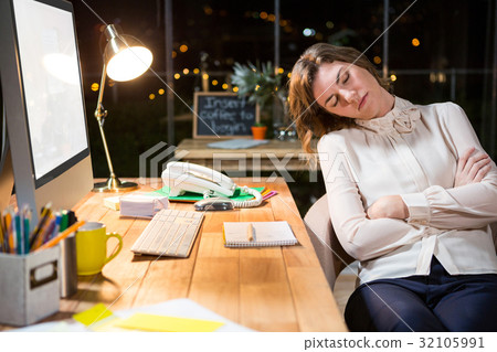 Tired businesswoman sleeping on chair Tired businesswoman sleeping on chair 32105991