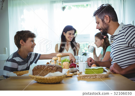 Happy family having breakfast 32106030